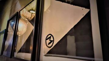 A window with a triangular cut-out and a circular symbol.