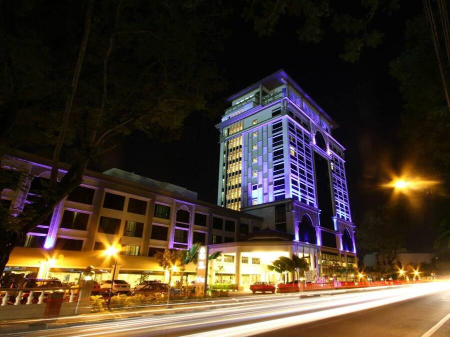 A multi-story hotel with a prominent tower and a ground-level building.