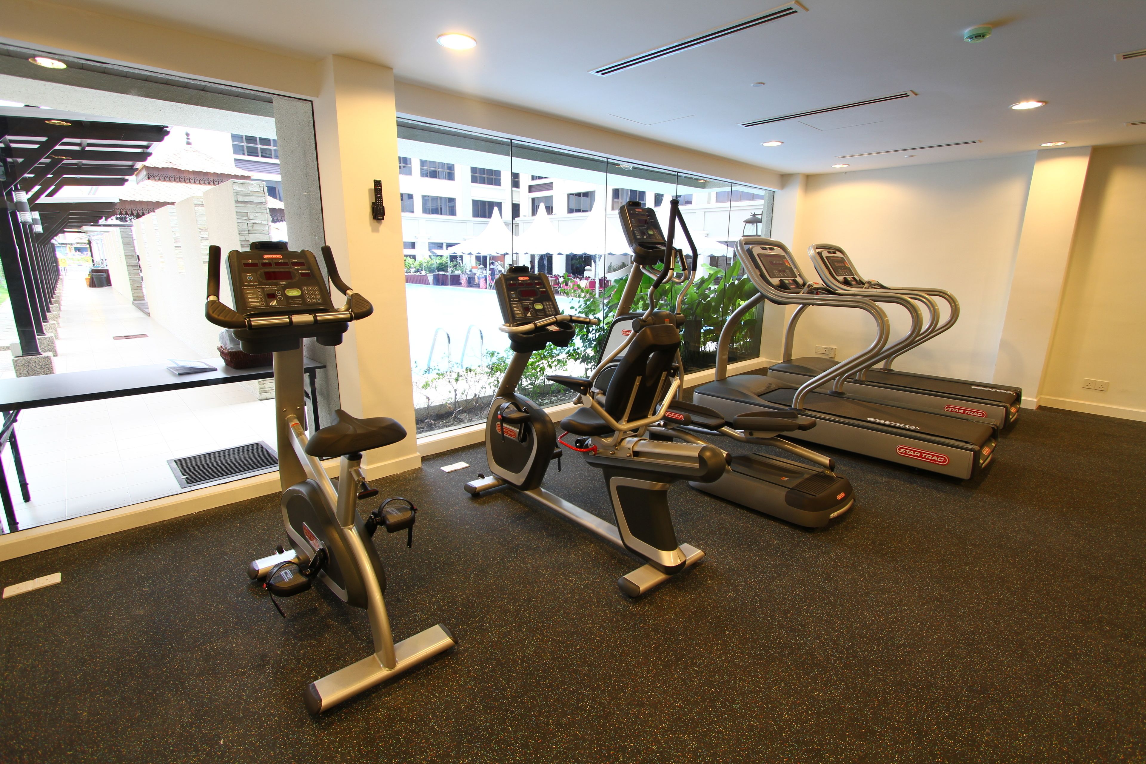 A gym with stationary bikes, an elliptical, and treadmills.