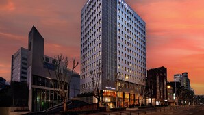 A high-rise hotel with a modern design, featuring a prominent 'MayPlace' sign on the facade. - Mayplace Seoul (Seoul)