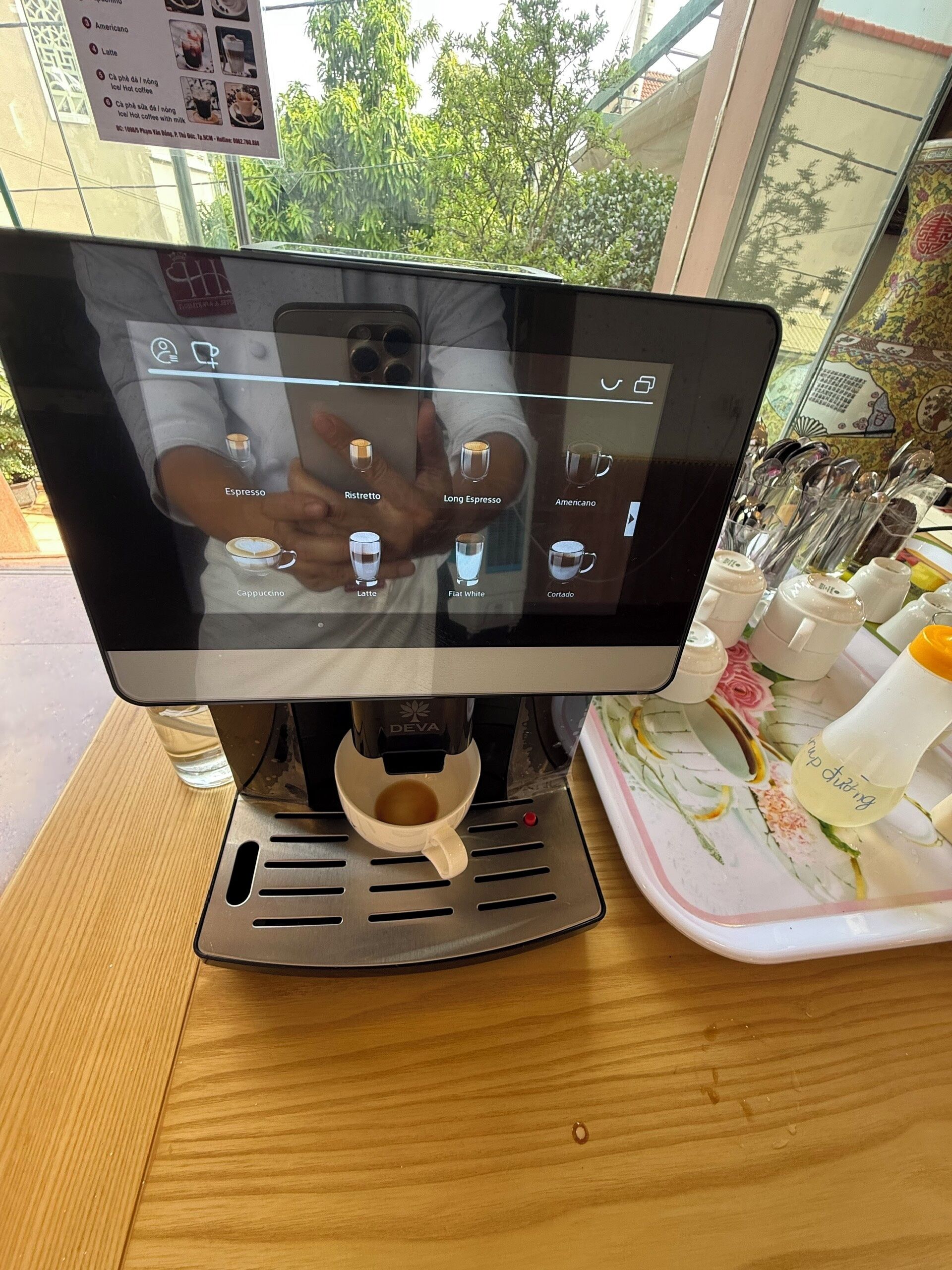 A coffee shop's digital menu board with various coffee options.