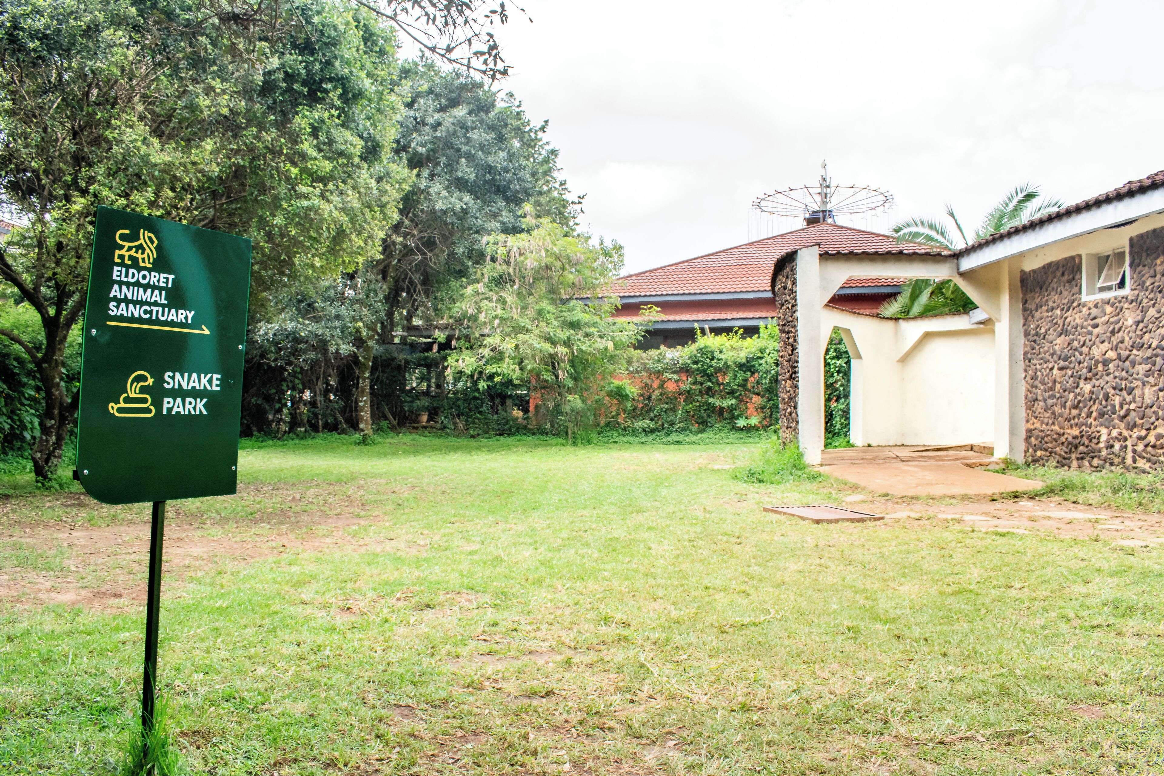 A sign for Eldoret Animal Sanctuary with a snake park symbol.