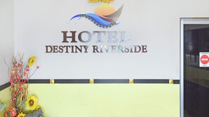 A sign for Hotel Destiny Riverside with a logo and decorative elements. - Hotel O Destiny Riverside Hotel (Kota Bharu)