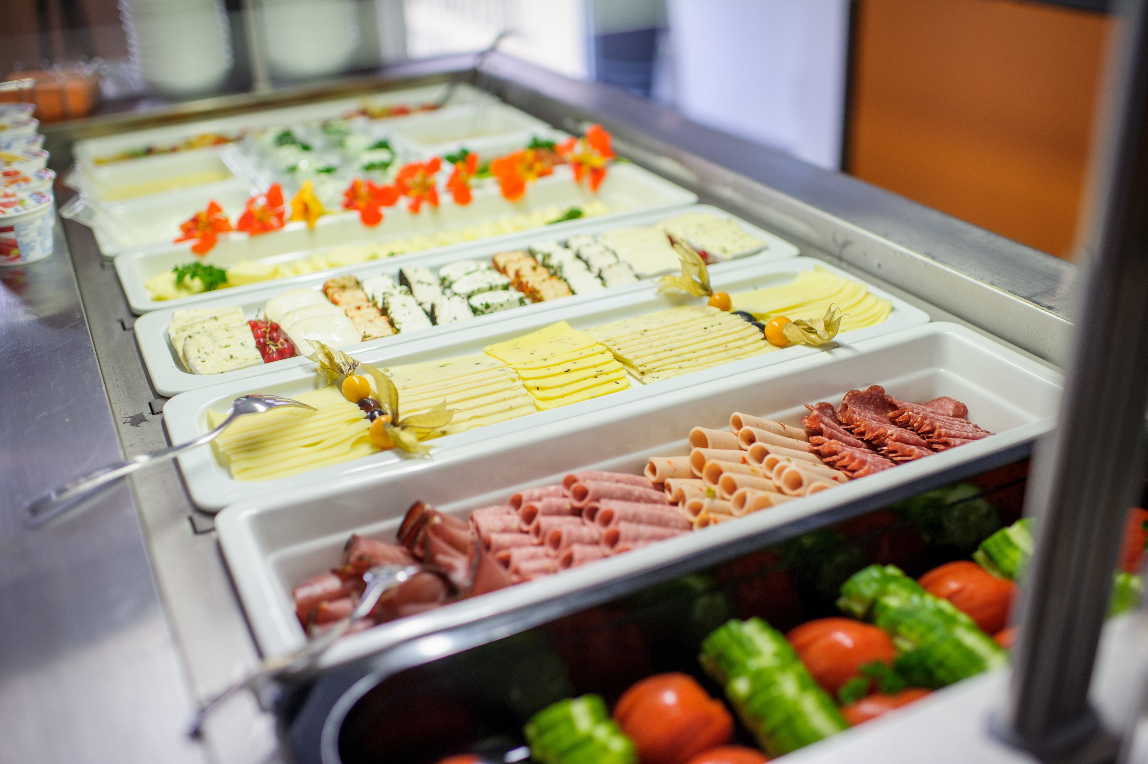 A buffet with various food options including pasta, meats, and vegetables.