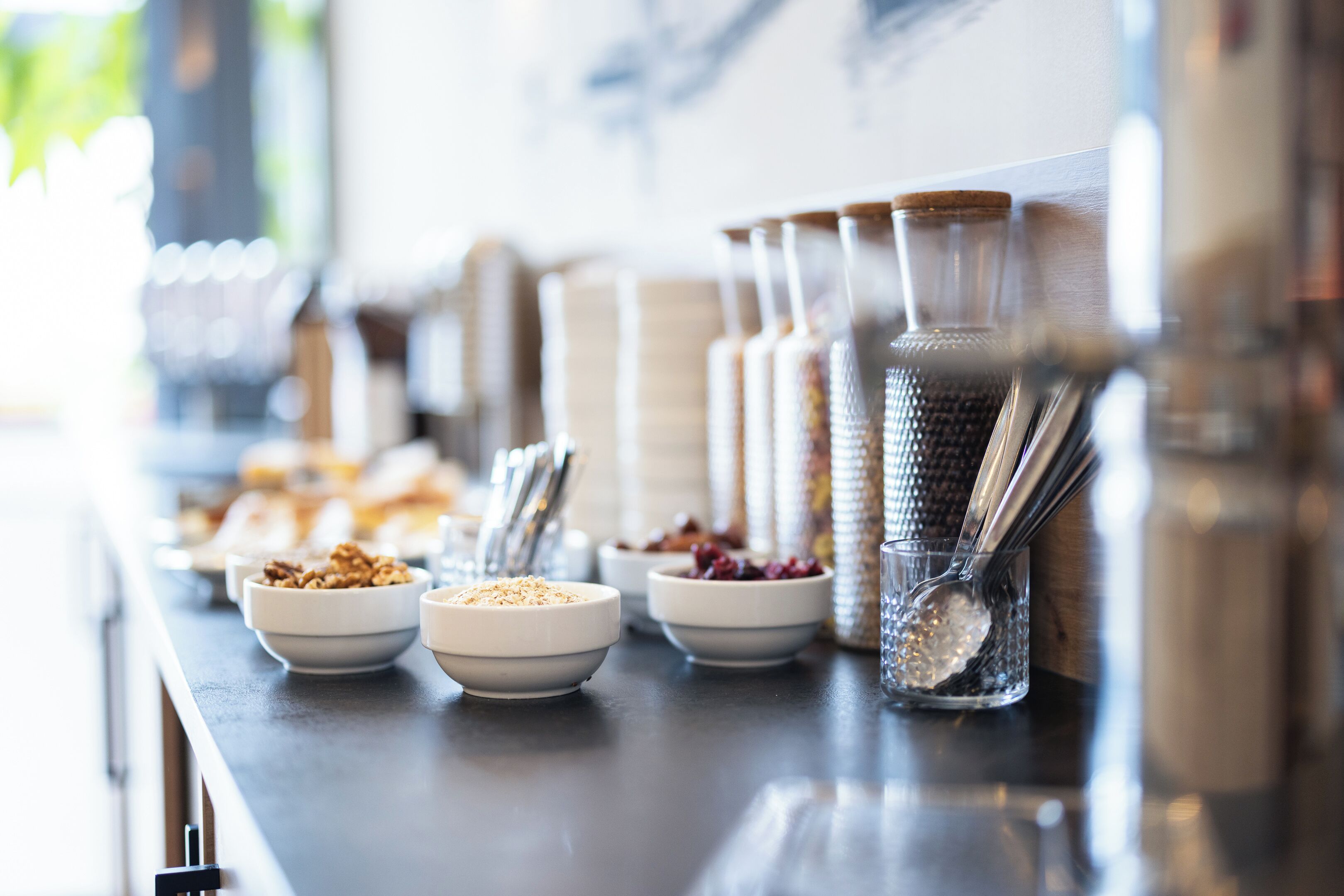 A breakfast buffet with various food items and utensils.