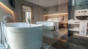 A modern bathroom with a large bathtub, a separate shower area, and a vanity with a bowl sink. - Sorli Emocions (Vilassar de Dalt)