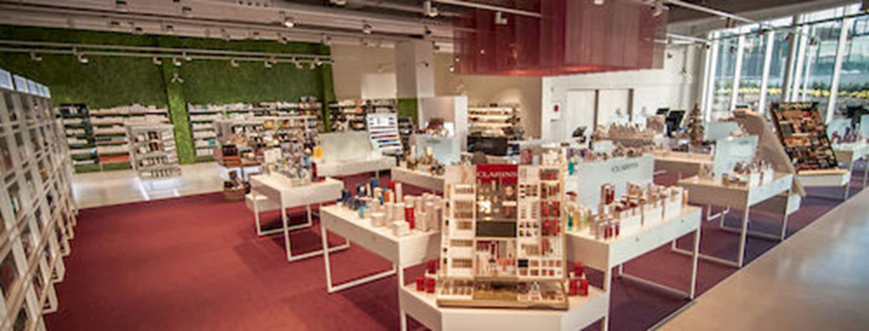 A spacious retail store with wide aisles and multiple display tables.