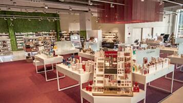 A spacious retail store with wide aisles and multiple display tables.