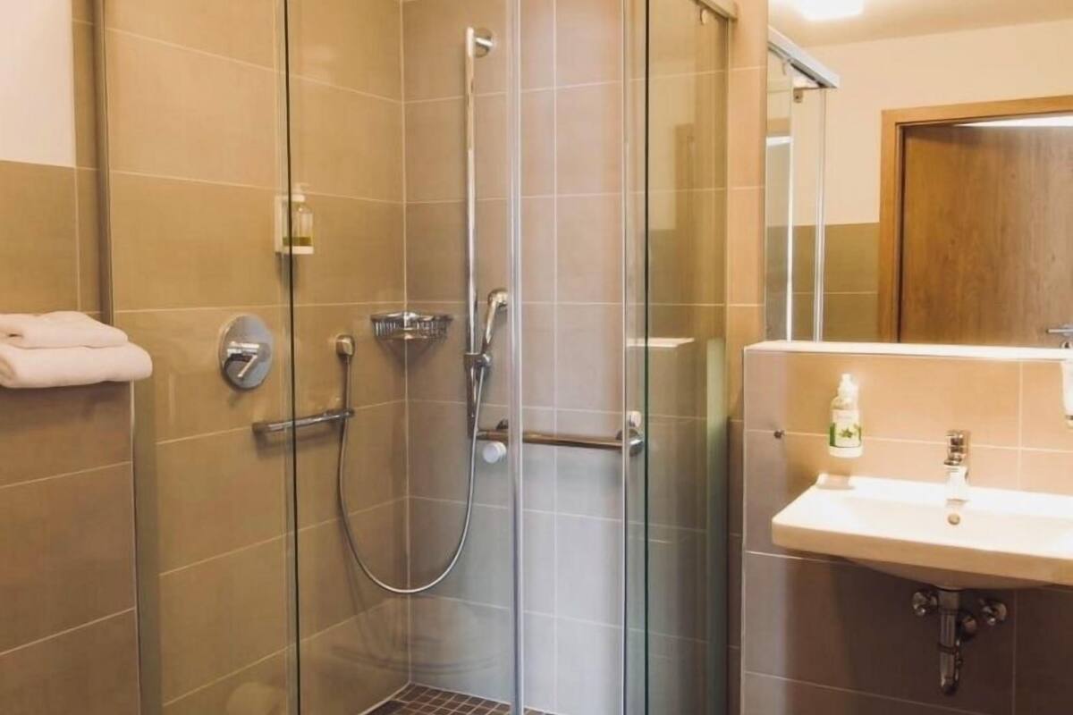 standard quadruple room | bathroom | shower, hair dryer, towels