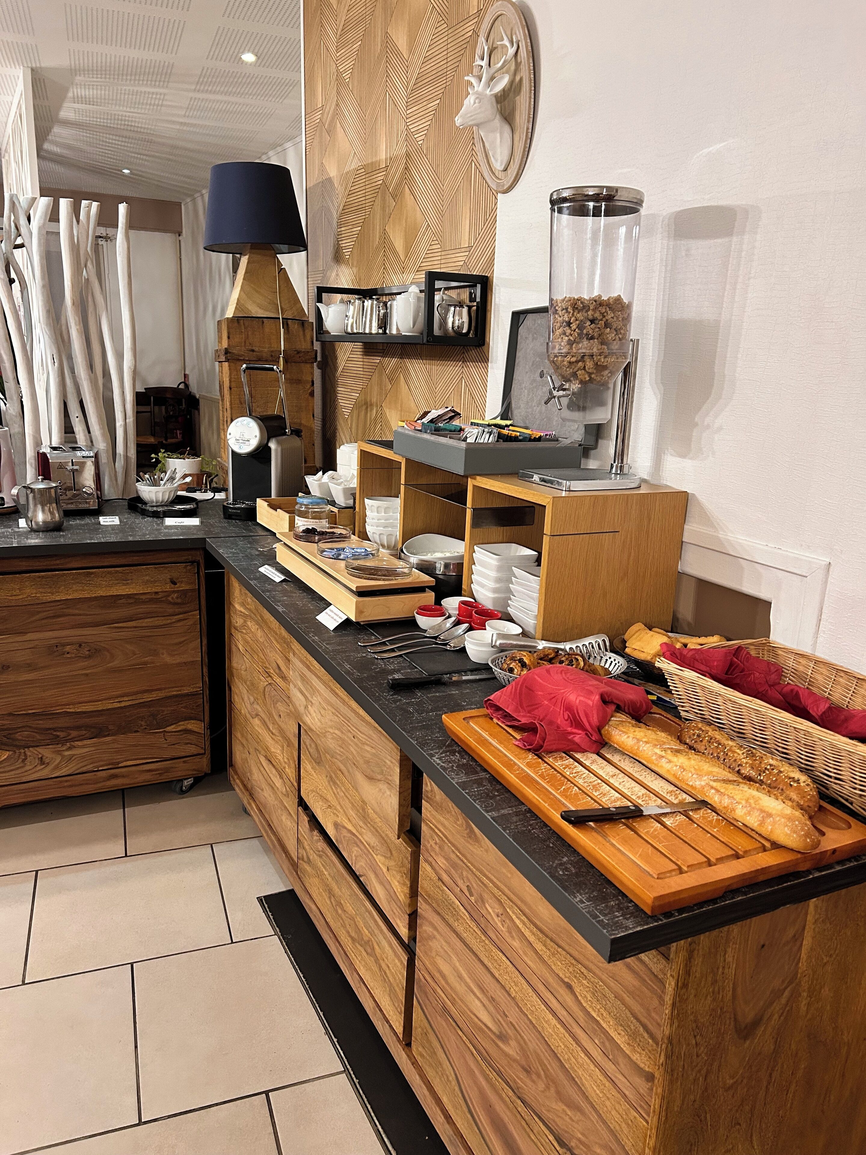 A kitchen with a wooden countertop, a coffee machine, and various kitchen utensils.