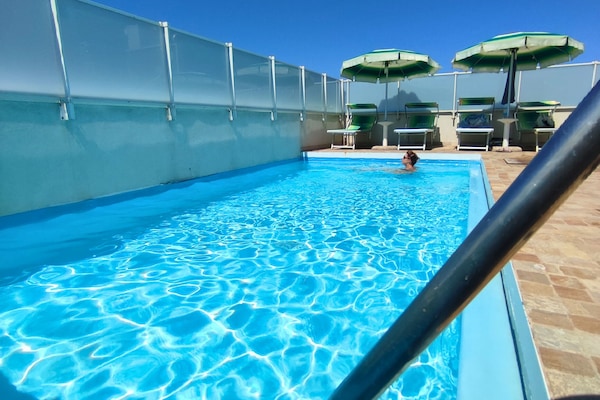 Outdoor pool, pool umbrellas, sun loungers