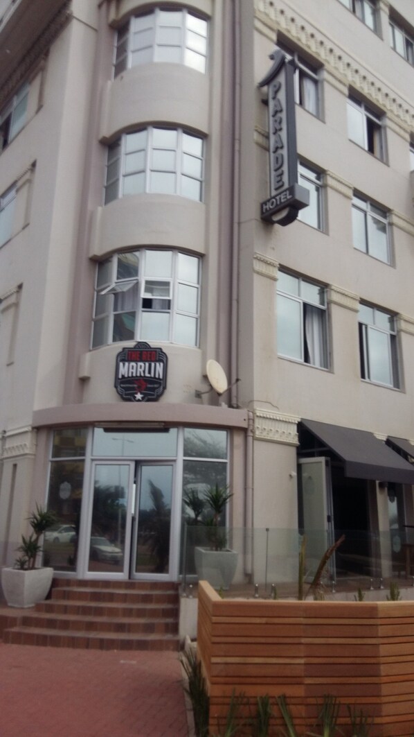 A hotel with a sign reading "MARLIN HOTEL" and a storefront with a sign reading "THE RED MARLIN." - Parade Hotel (Durban)