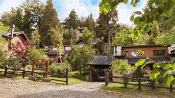 A rustic lodge with multiple wooden cabins surrounded by dense forest.