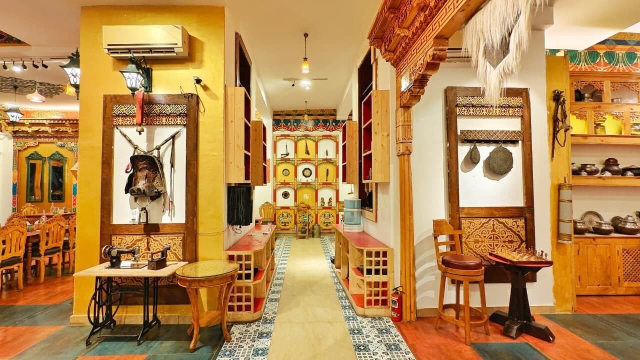 A traditional interior with a central aisle, wooden furniture, and decorative elements.