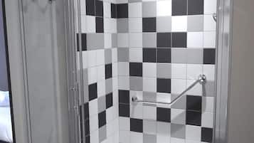 A shower area with a glass door, a checkered black and white tile wall, and a showerhead.