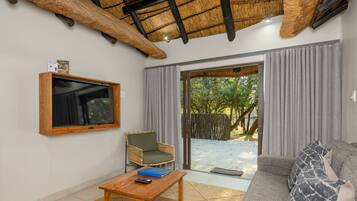 Two Bedroom Apartment with Patio | Living area | Flat-screen TV