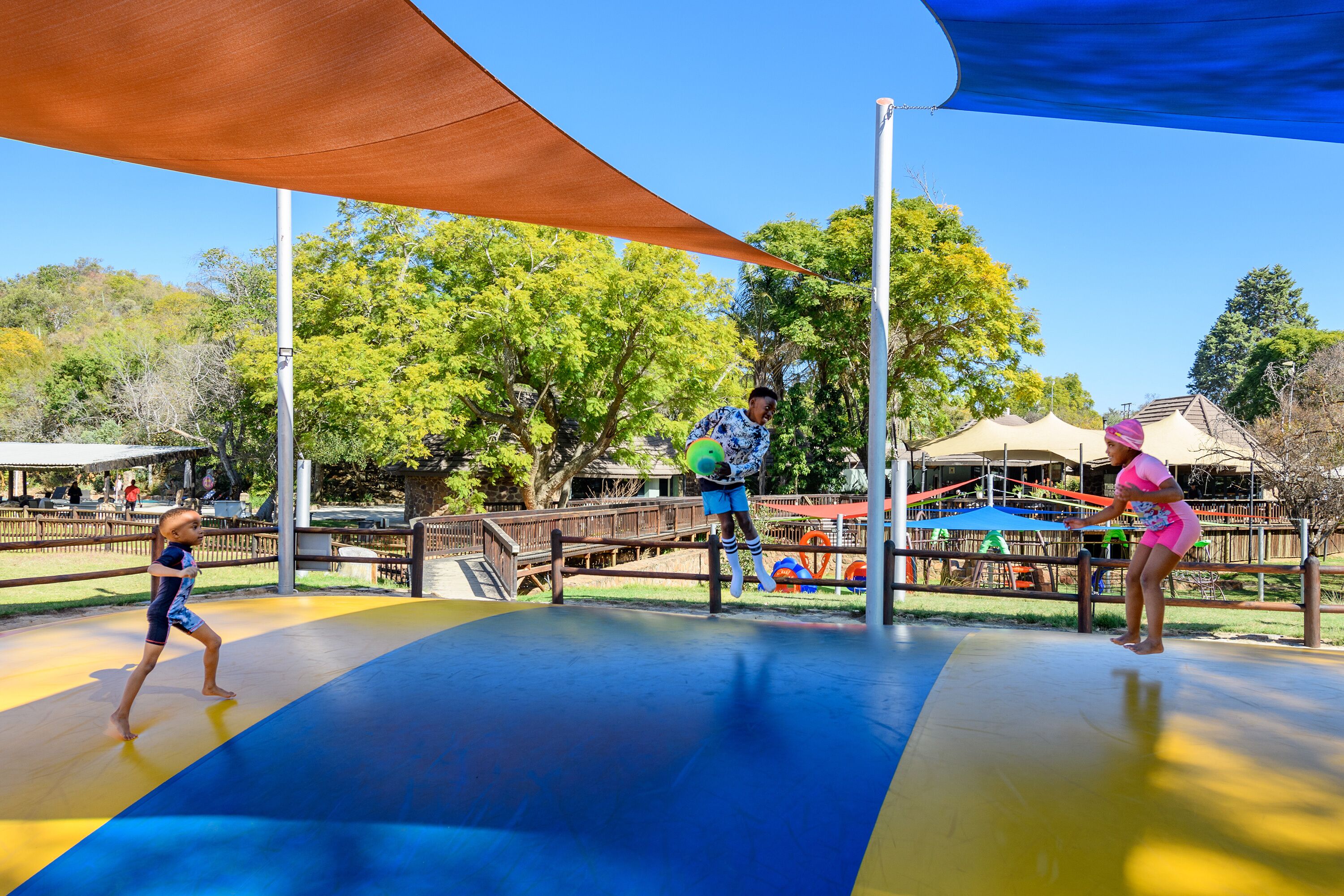 A playground with a slide and climbing structures.