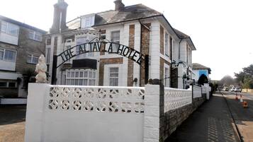 Experience the charm of The Altavista Hotel, a traditional building with a classic architectural style and a prominent entrance gate.