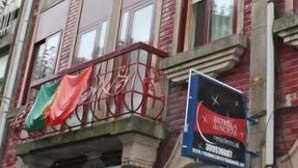A multi-story building with a balcony and a flag. - Guest House Estrela (Porto)