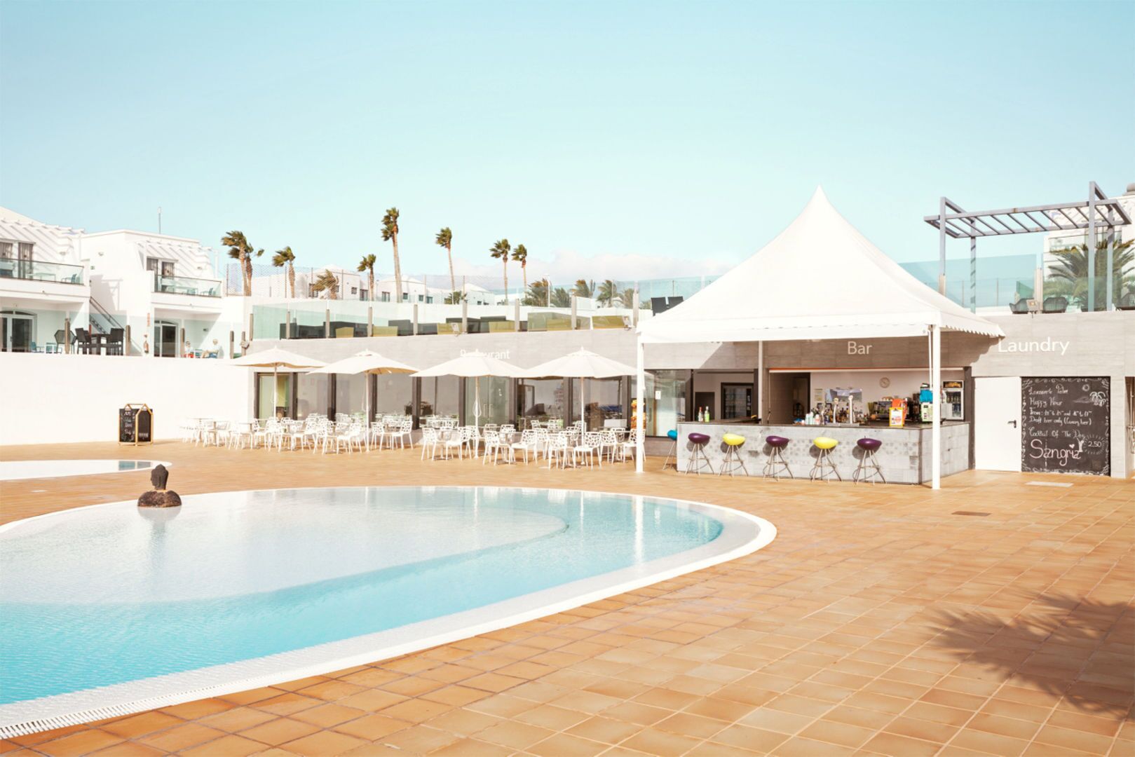 Un área de piscina con bar y lavandería.