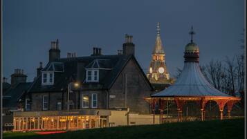 A building with a clock tower and a gazebo.