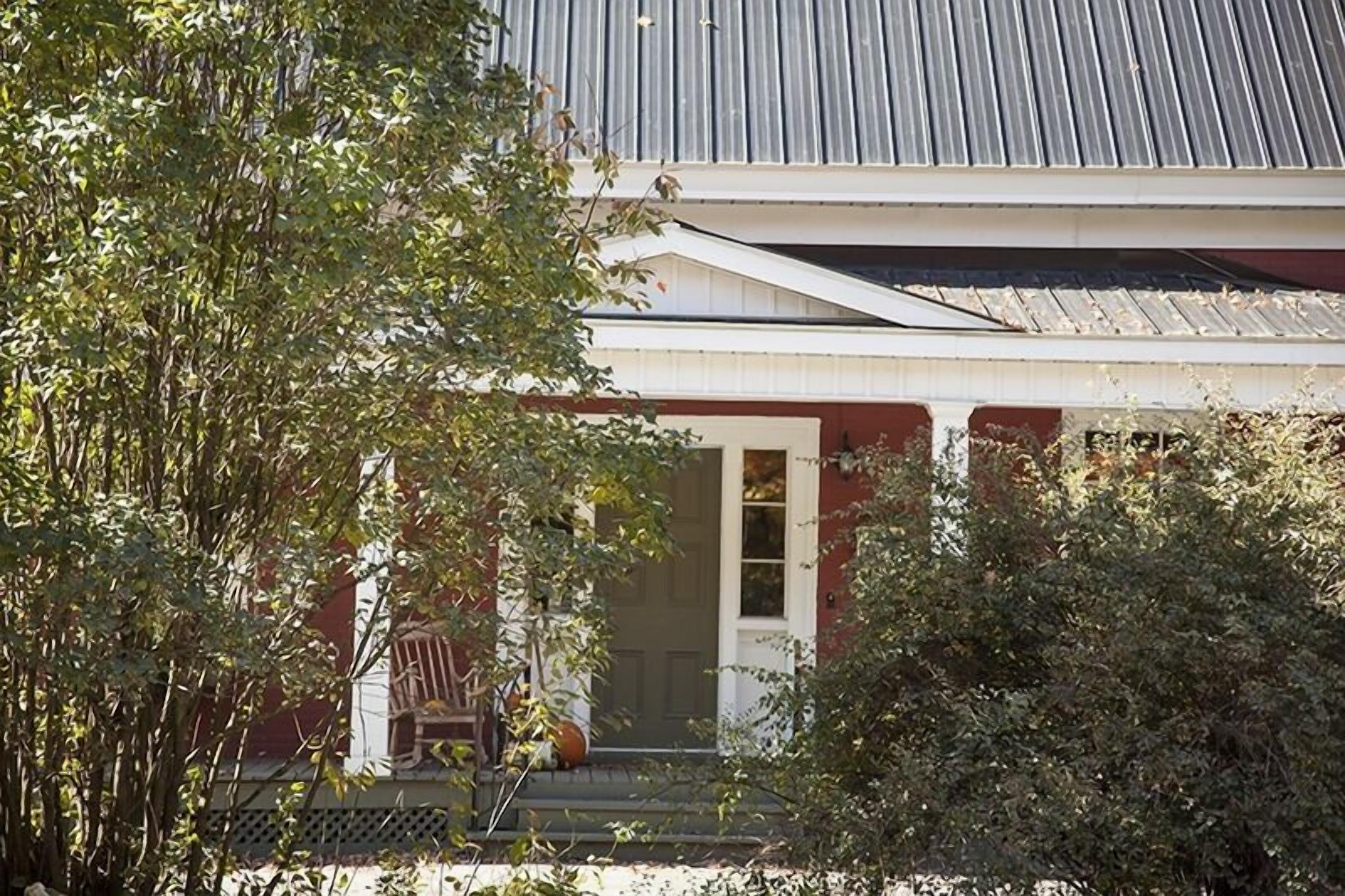 A house with a porch, a door, and a window.