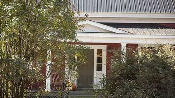 A house with a porch, a door, and a window.