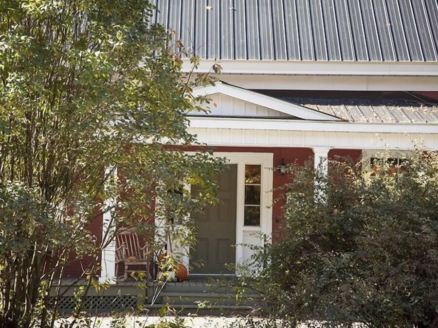 A house with a porch, a door, and a window.