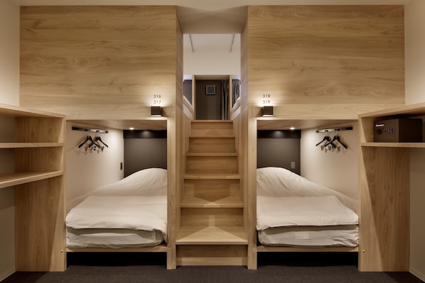 A compact room with two beds, a staircase, and a small door at the top. - Piece Hostel Sanjo (Kyoto)