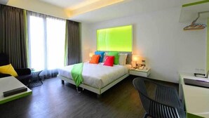 A modern hotel room with a bed, bedside tables, a desk, and a chair. - The Lime Boutique Suites (Hyderabad)