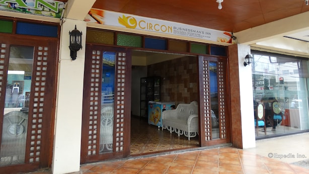 A hotel entrance with a Circon Businessman's Inn sign, a tiled floor, and a glass door with a patterned design. - Circon Businessman's Inn (Puerto Princesa)