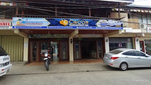 A building with a sign for Circon Businessman's Inn and a motorcycle parked in front. - Circon Businessman's Inn (Puerto Princesa)