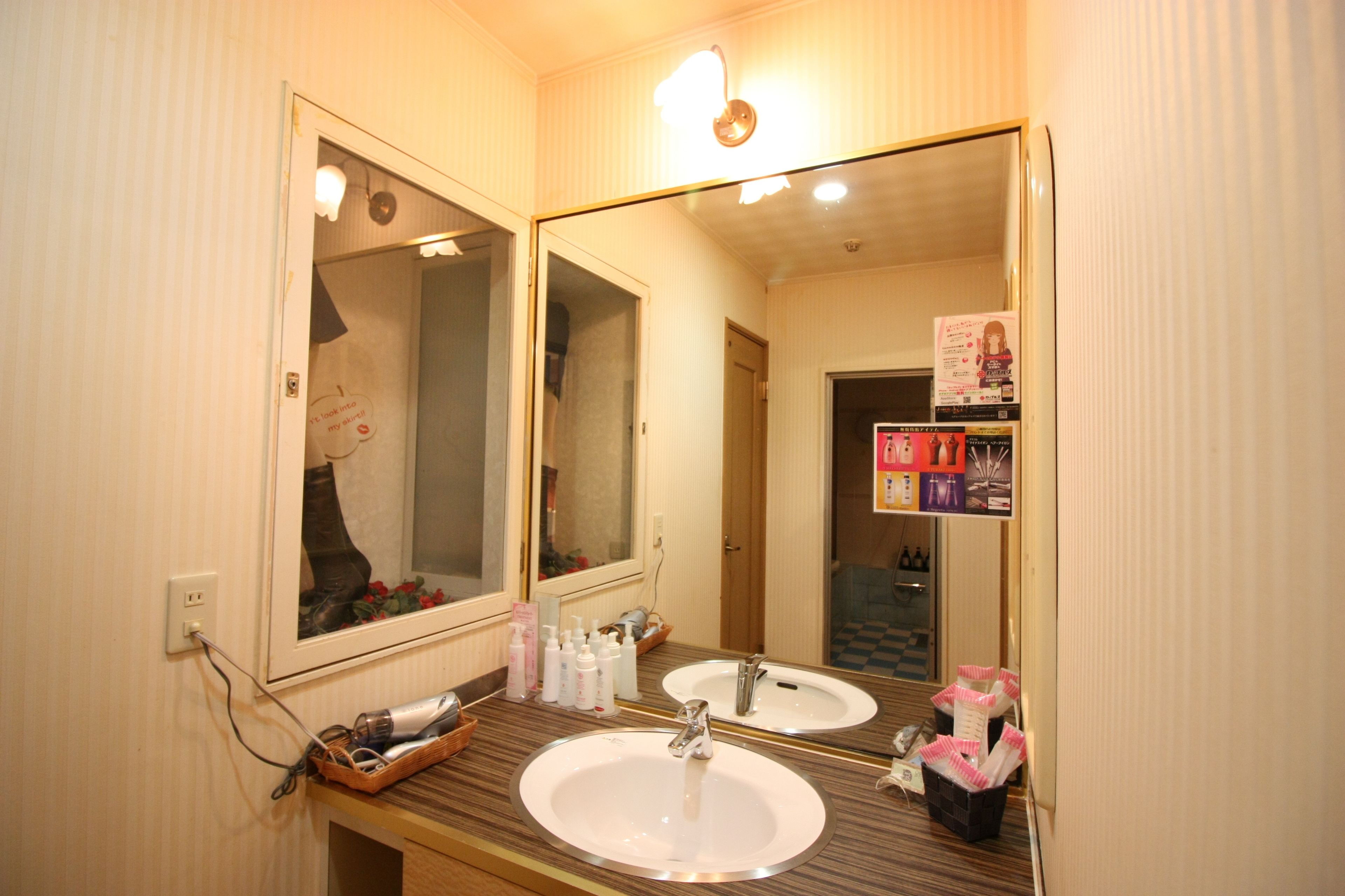 A bathroom with two sinks, a mirror, and a towel rack.