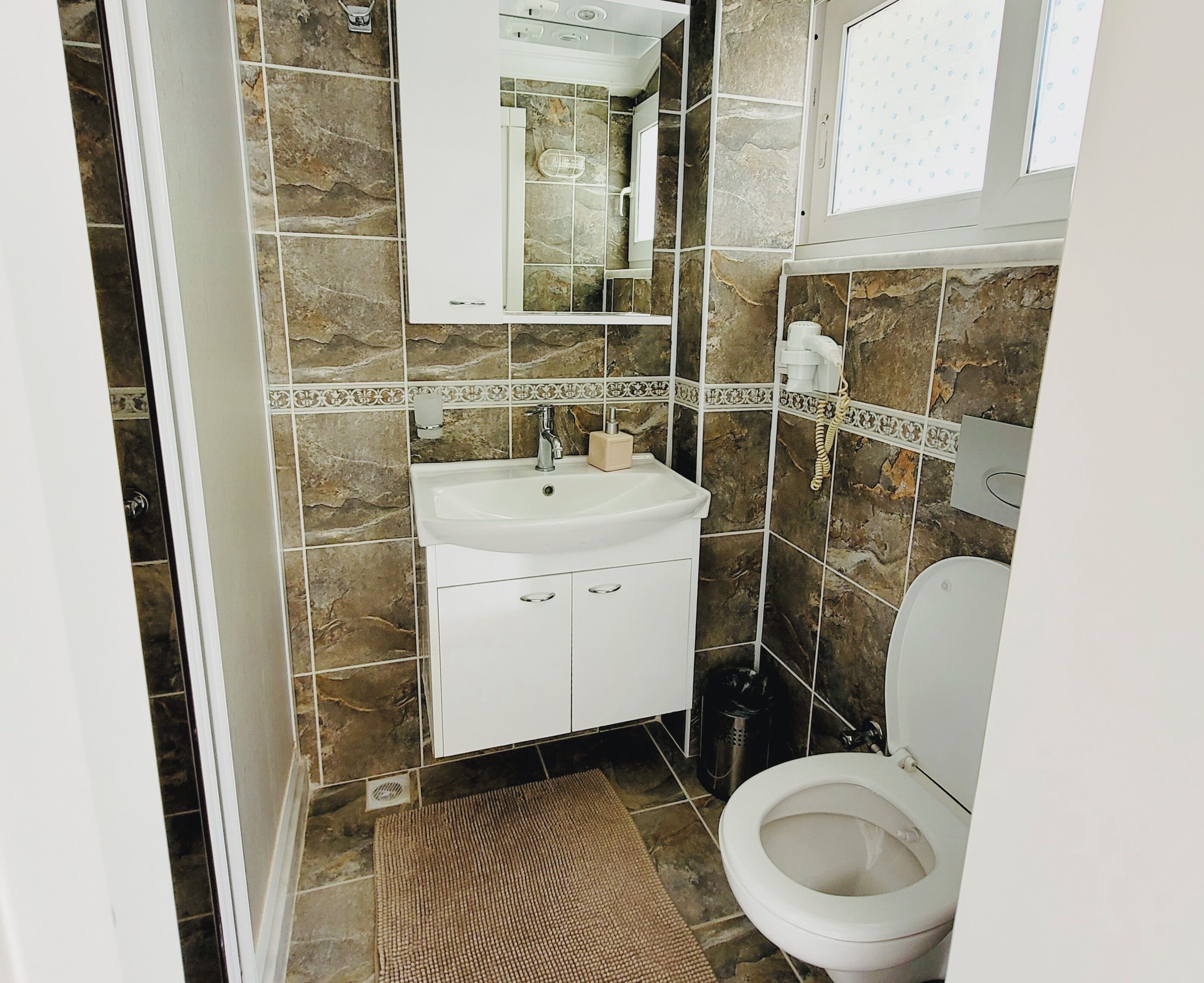 shower, hair dryer, slippers, towels