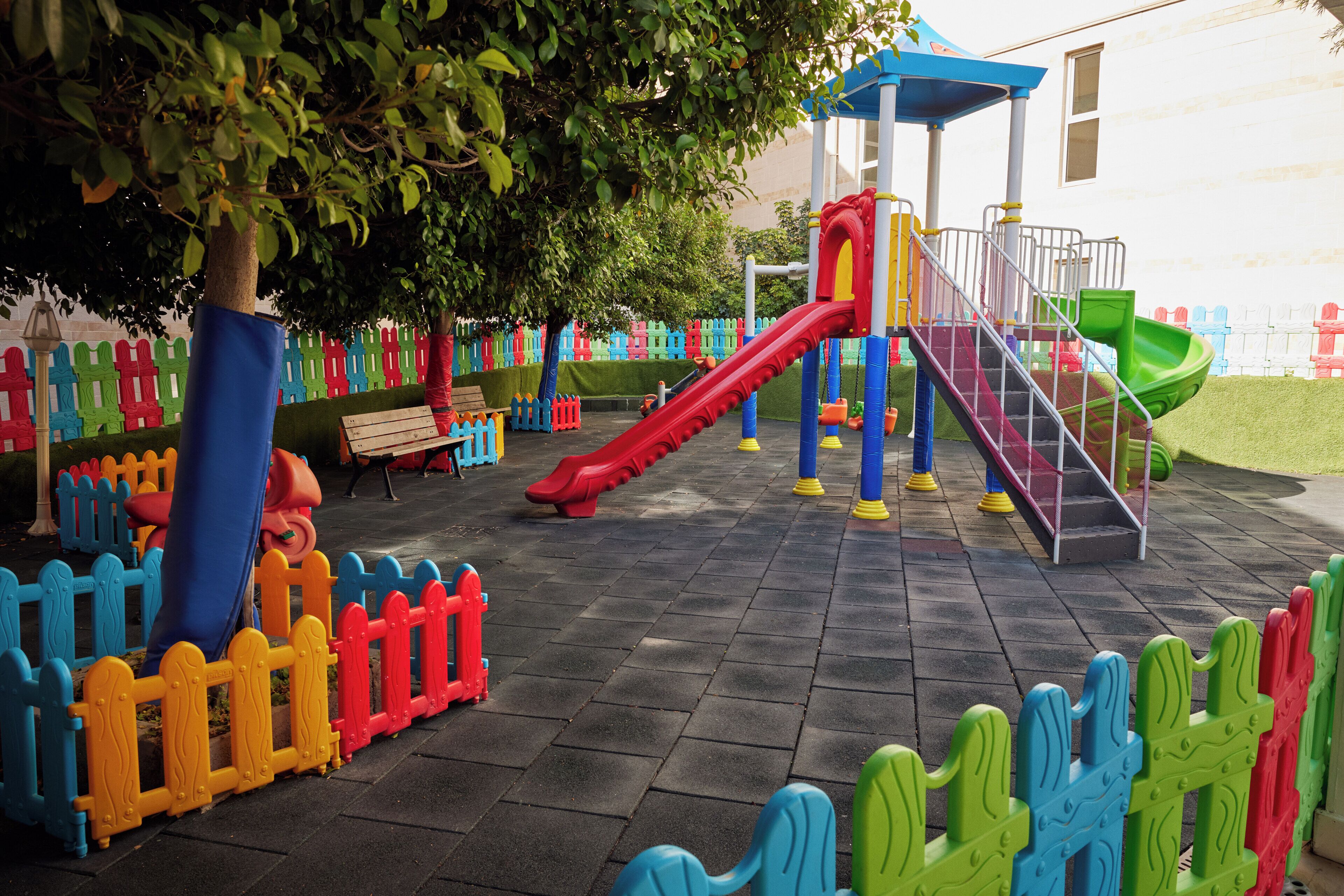 A playground with slides and a climbing structure.
