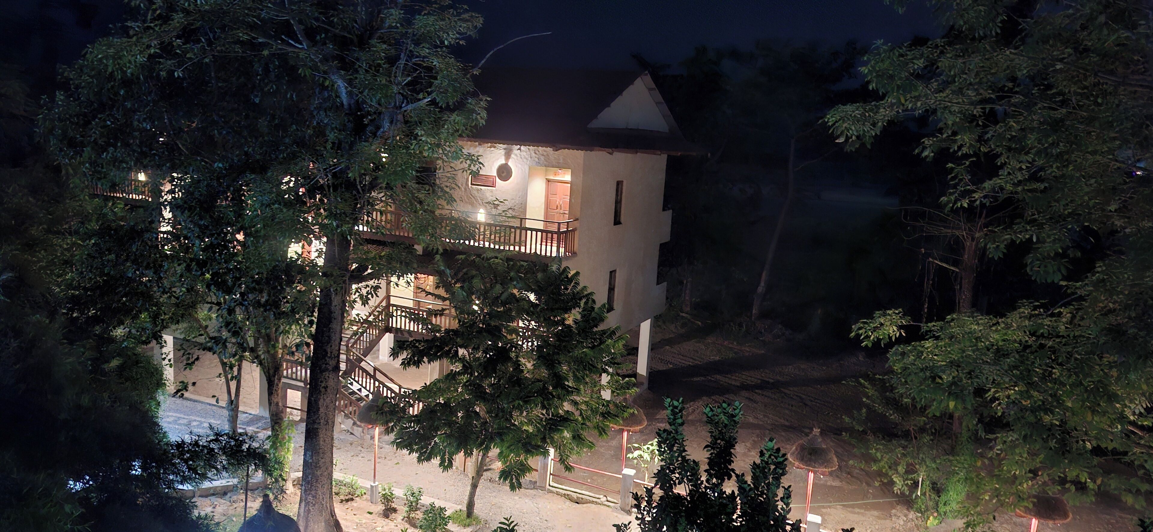 A two-story building with a balcony and a staircase.