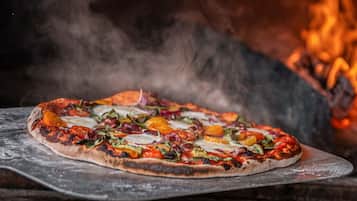 Una pizza sobre una tabla de madera con un fondo rústico.