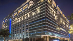 A modern hotel with multiple floors, large windows, and a well-lit facade. - Le Meridien Dhaka (Dhaka)