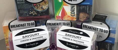A display of breakfast products with labels indicating they are made with corn oats and wheat.