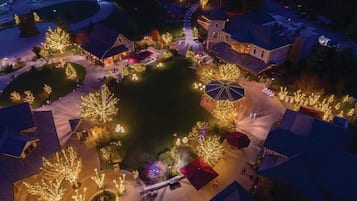 An aerial view of a residential area with houses, trees, and a central open space with a gazebo.