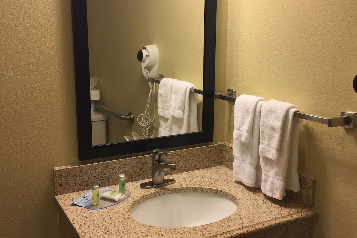 designer toiletries, hair dryer, towels, soap