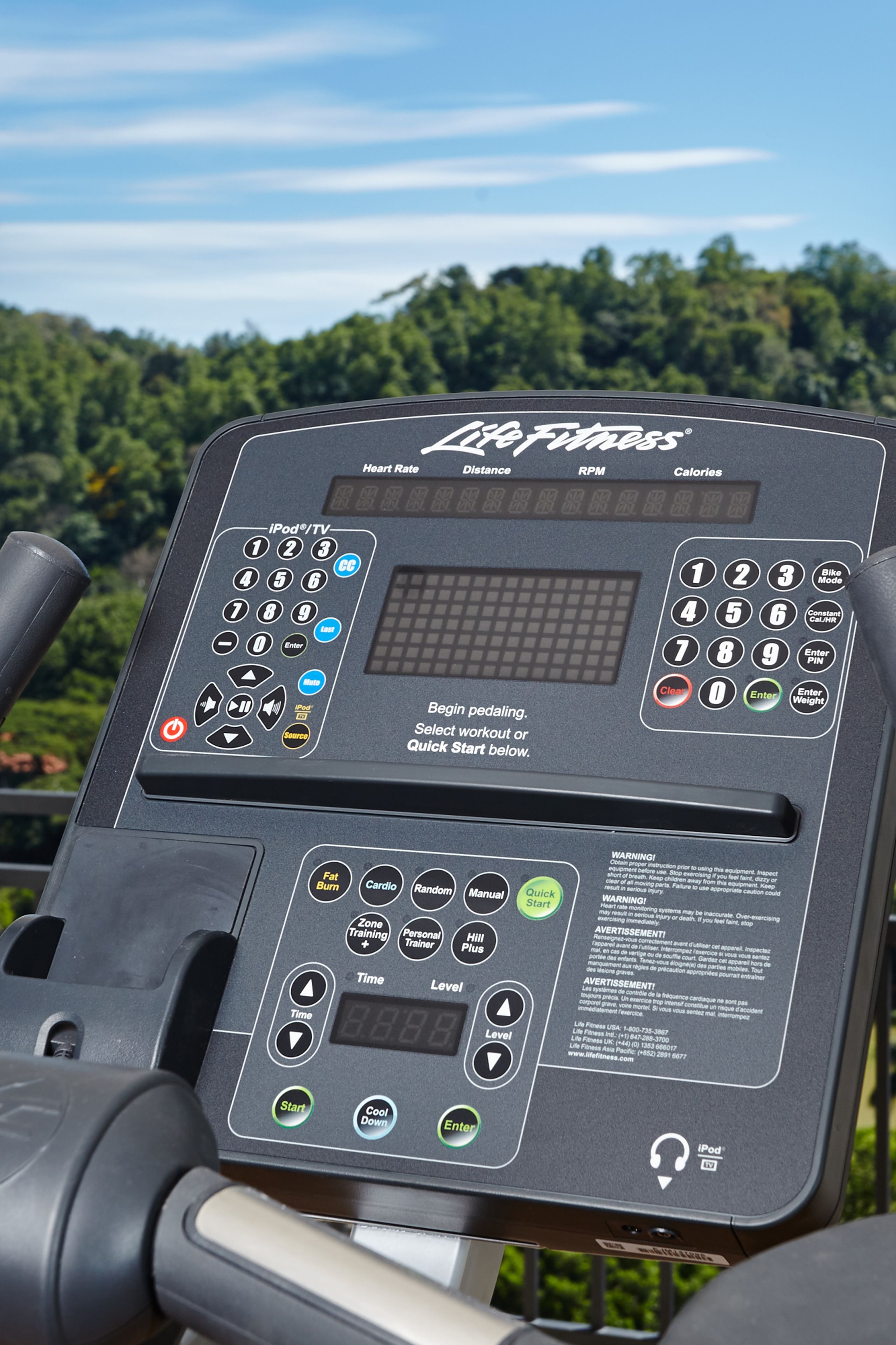 A cardio machine with a digital display, control panel, and various workout options.
