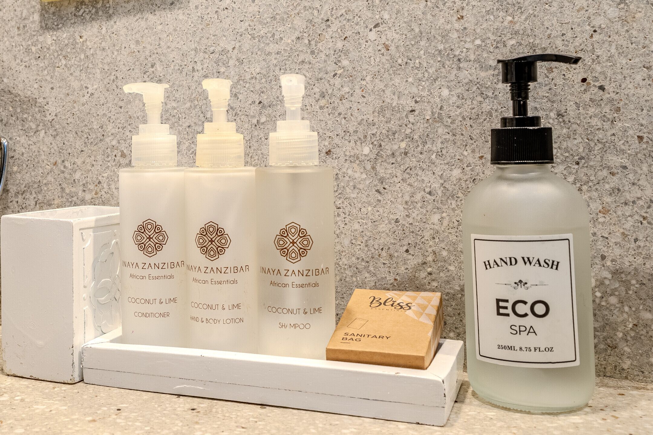 A set of hand wash products including a bottle of hand wash soap and three bottles of lotion.