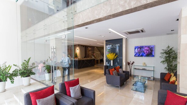 A modern hotel lobby with glass walls, a reception desk, and seating areas. - Nicecy Ben Thanh Hotel (Ho Chi Minh City)