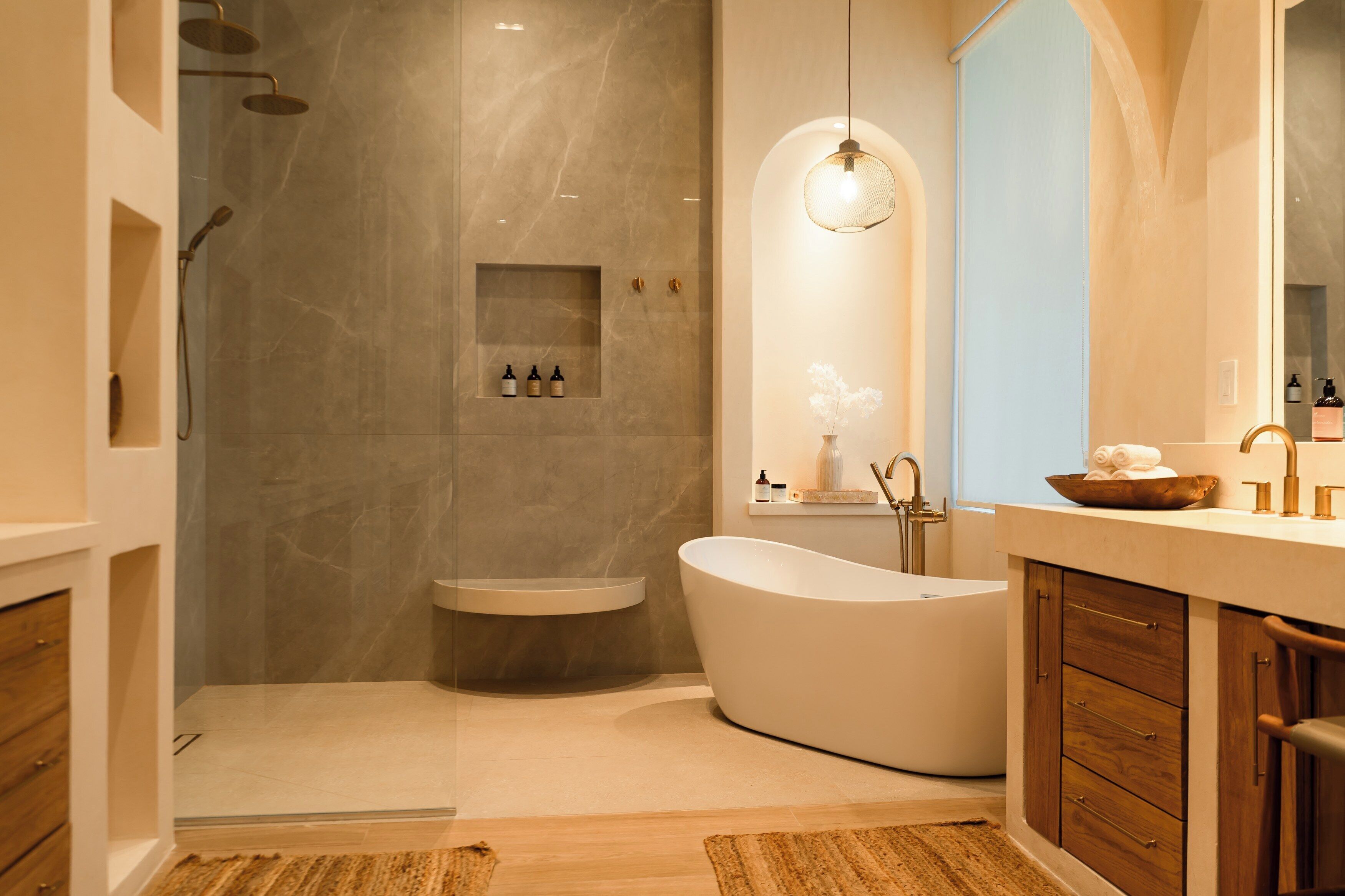 A modern bathroom with a freestanding bathtub, a walk-in shower, and a vanity with a mirror.