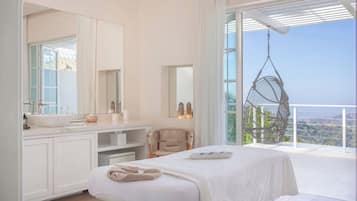 A modern bedroom with a large window, a hanging chair, a bedside table, and a built-in bench.