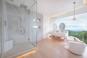 A modern bathroom with a glass-enclosed shower, a freestanding bathtub, and a vanity with a large mirror. - The Retreat Costa Rica - Wellness Resort & Spa (Jesús)