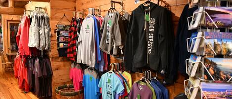 A clothing store with racks of various shirts and jackets.