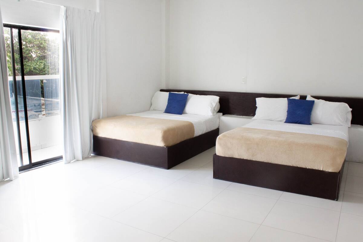 Standard Quadruple Room | Minibar, in-room safe, iron/ironing board (on request), bed sheets