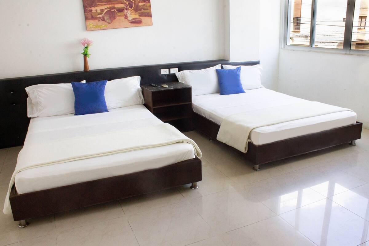 Standard Triple Room | Minibar, in-room safe, iron/ironing board (on request), bed sheets